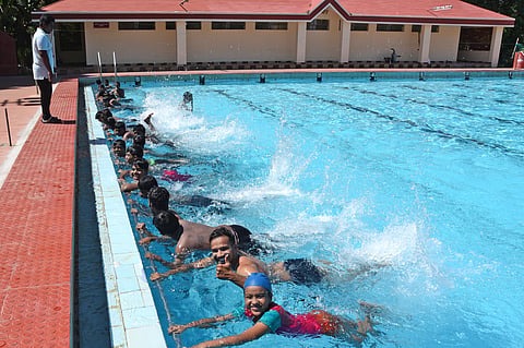 Young professionals and students attend a summer swimming camp at Anna Stadium pool in Tiruchy