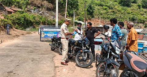 Police verifying the records of the commuters at the new check post set up at Eguva Simbi village in the disputed Kotia region.