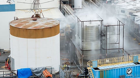Water is sprayed on a damaged tank at GKN Aerospace in Garden Grove, Calif., on Sunday, May 24, 2026, after the tank containing a chemical used to make plastic parts overheated Thursday.