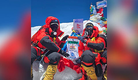 Santhosh Devarajappa and Chinmayee Thrishulamurthy pose for a picture at the top of Mount Everest.