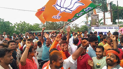BJP supporters wave the party flag after winning in the repoll to West Bengal's Falta Assembly seat, in South 24 Parganas, Sunday, May 24, 2026