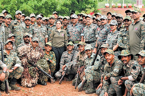 Home Minister V Anitha with Greyhounds personnel in Vizag on Monday.