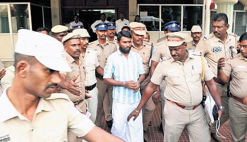 Convict M Dharma Muneeswaran being escorted under police protection to the Special Pocso Court in Thoothukudi on Monday.
