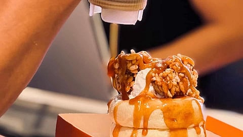Server prepares a miso-caramel souffle pancake at O'fufu