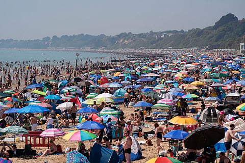 People visit Bournemouth beach, south England, Monday May 25, 2026.