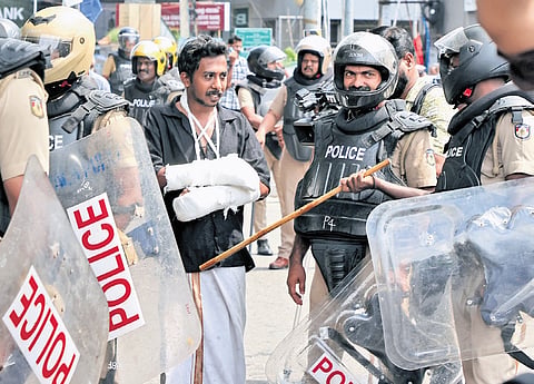SFI district secretariat member Manesh M, who was injured in police action at Palayam in Thiruvananthapuram on Monday, having a conversation
with police officers during the student organisations’s protest march to the Secretariat on Tuesday