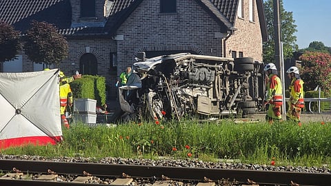 Rescue workers on the scene of a crash between a train and vehicle in Buggenhout, Belgium, Tuesday, May 26, 2026.