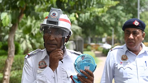 Delhi Traffic Police tests AC helmets, portable fans to help personnel beat heat, in New Delhi on Monday.