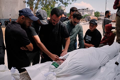 Palestinians mourn over the body of Mohammad Odeh, whom Israel says was a leader of Hamas Qassam Brigades, a day after he was killed in an Israeli airstrike, during his funeral in Gaza City, Wednesday, May 27, 2026.
