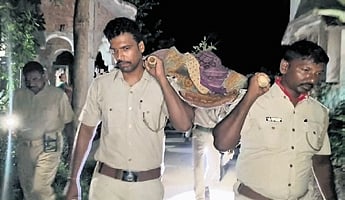 Police personnel carrying Tulasi’s body