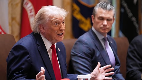 President Donald Trump speaks during a Cabinet meeting at the White House, Wednesday, May 27, 2026, in Washington, as Secretary of Defense Pete Hegseth, looks on.