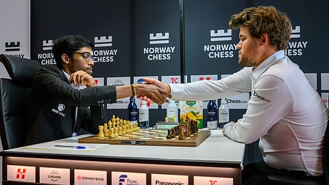 Indian Grandmaster R Praggnanandhaa world No. 1 Magnus Carlsen shake hands before the start of the game.