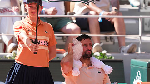 Novak Djokovic of Serbia cools himself with the ice during a break of the second round men's singles tennis match against Valentin Royer of France at the French Open tennis tournament in Paris, Wednesday, May 27, 2026.