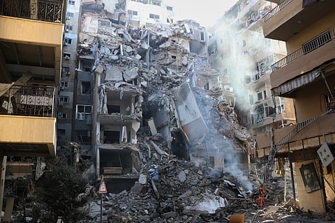 Rescue workers search for victims inside a destroyed apartment that was hit in an Israeli airstrike in the southern port city of Sidon, Lebanon, Thursday, May 28, 2026.