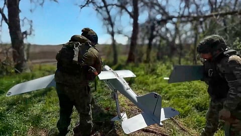 In this image made from video provided by Russian Defense Ministry Press Service on Wednesday, May 27, 2026., Russian servicemen prepare to launch an interceptor drone for an action in an undisclosed location in Ukraine.