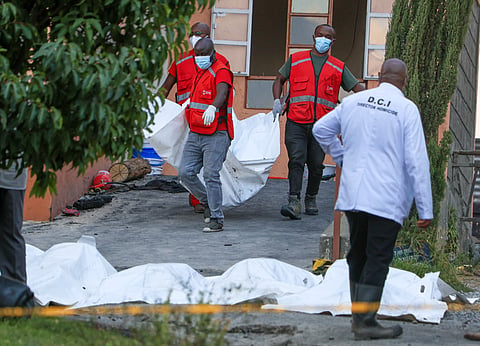 Red Cross members recover the bodies of students who died in the fire at the Utumishi Girls School in the Gilgil area, central Kenya, Thursday, May 28, 2026.