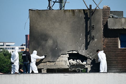 Police and forensic investigators examine the location of impact after a Russian drone struck an apartment building in Galati, eastern Romania.
