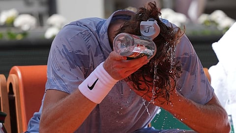Jannik Sinner of Italy cools himself with the water during a break at the second round men's singles tennis match against Juan Manuel Cerundolo of Argentina at the French Open tennis tournament in Paris, Thursday, May 28, 2026