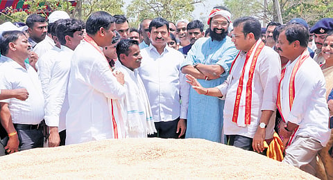 Ministers N Uttam Kumar Reddy, D Sridhar Babu and Ponguleti Srinivasa Reddy interact with farmers during their visit to Vangapally paddy purchase centre