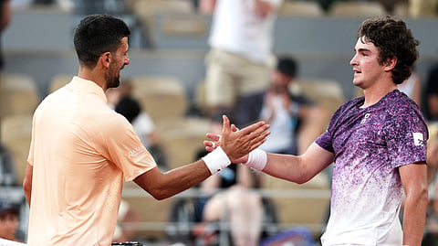 Brazil's Joao Fonseca (R) greets Serbia's Novak Djokovic at the end of their men's singles match on day 6 of the French Open tennis tournament on Court Philippe-Chatrier at the Roland-Garros Complex in Paris on May 29, 2026.
