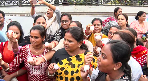 Women throw eggs at TMC General Secretary Abhishek Banerjee, unseen, during his visit to the families of post-poll violence victims, in Sonarpur, West Bengal, Saturday, May 30, 2026.