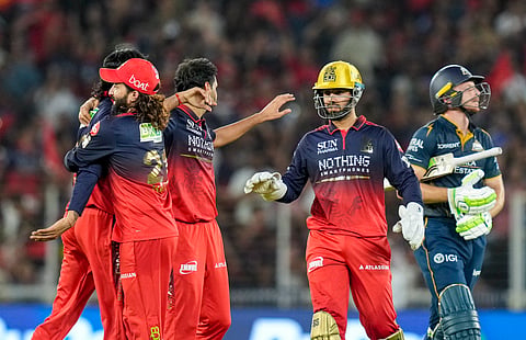 Royal Challengers Bengaluru's players celebrate after the wicket of Gujarat Titans' Jos Buttler during the Indian Premier League (IPL) 2026 Final T20 cricket match between Royal Challengers Bengaluru and Gujarat Titans, in Ahmedabad, Gujarat, Sunday, May 31, 2026