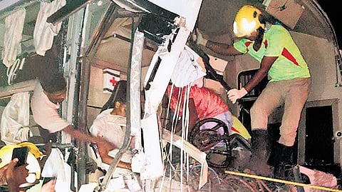 Fire and Rescue Services personnel extricating passengers from the mangled remains of the omni bus at Ponnakudi in Tirunelveli