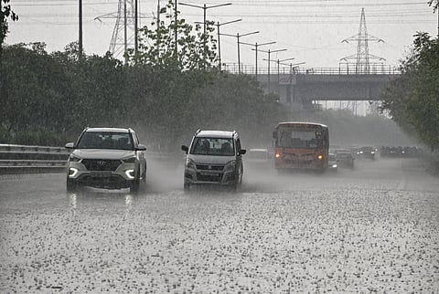 Vehicles move on a road amid rainfall, in Noida, Sunday, May 31, 2026.