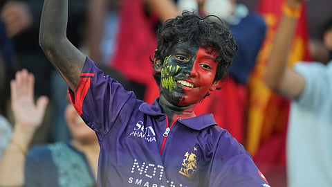 A Royal Challengers Bengaluru fan cheers as he waits for the start of the Indian Premier League final cricket match between Gujarat Titans and Royal Challengers Bengaluru in Ahmedabad, India, Sunday, May 31, 2026.