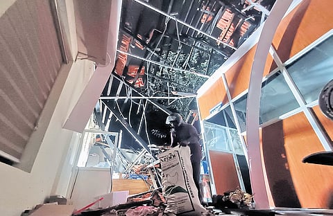 Workers salvage office materials from the Attakulangara School campus in Thiruvananthapuram after a part of the roof collapsed on Monday evening