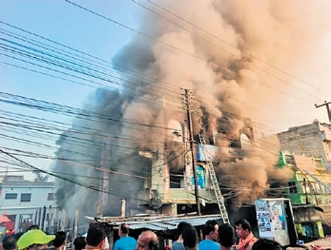 The G+2 building in flames after fire erupted in the adjacent fish market