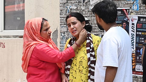 Daughter of victim Parvati in tears after receiving the tragic news.