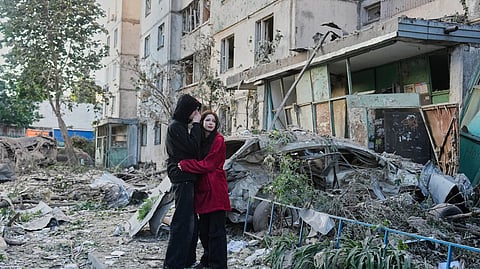 People react as they look at the site of Russian missile strike that hit a residential building in Kyiv, Ukraine, Tuesday, June 2, 2026.