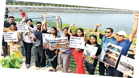 Members of Voice of Sadashivanagar hold a demonstration to raise awareness as part of Save Sankey Lake movement in Bengaluru on Sunday.