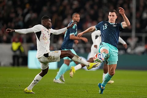 Thomas Partey of Ghana and Nico Schlotterbeck of Germany challenge for the ball during an international friendly soccer match between Germany and Ghana in Stuttgart, Germany, March 30, 2026.
