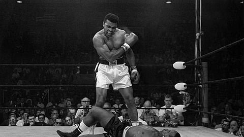 Heavyweight champion Muhammad Ali stands over fallen challenger Sonny Liston, shouting and gesturing shortly after dropping Liston with a short hard right to the jaw on May 25, 1965, in Lewiston, Maine.