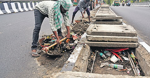GBA workers clean Nayanadahalli flyover ahead of the onset of monsoon in Bengaluru on Wednesday.