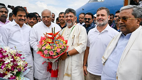 Karnataka Chief Minister DK Shivakumar greets senior congress leaders at HAL Airport in Bengaluru.