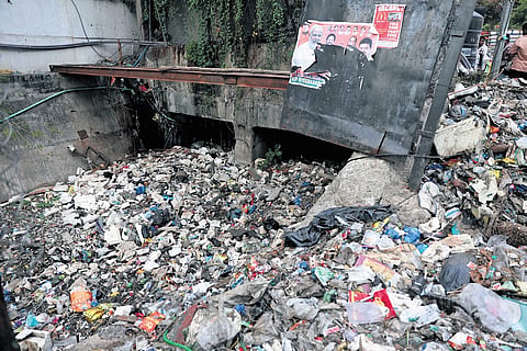 Garbage accumulated at the inlet of a stormwater drain near the Khairatabad Metro station in Hyderabad on Tuesday