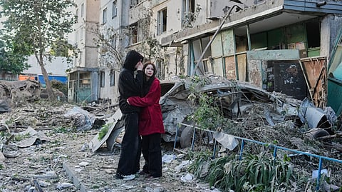 People react as they look at the site of a Russian missile strike that hit a residential building in Kyiv, Ukraine, Tuesday, June 2, 2026.