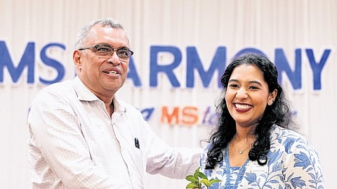 Merin Theres John receiving a memento during the launch of MS Harmony from Dr Mathew Abraham, a neurologist at Aster Medcity