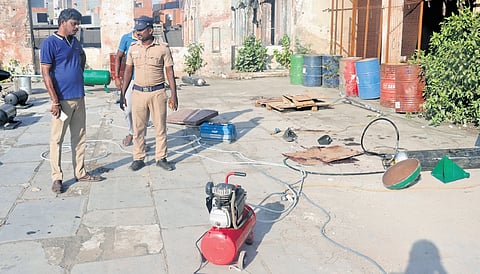 Police inspect the spot at Binny Mills premises where the blast killed Madhavan (inset) on Wednesday | Express