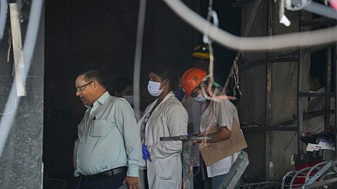 Forensic officials at the site after a fire broke out at a bed-and-breakfast in a five-storey building in south Delhi's Malviya Nagar area, Wednesday, June 3, 2026.