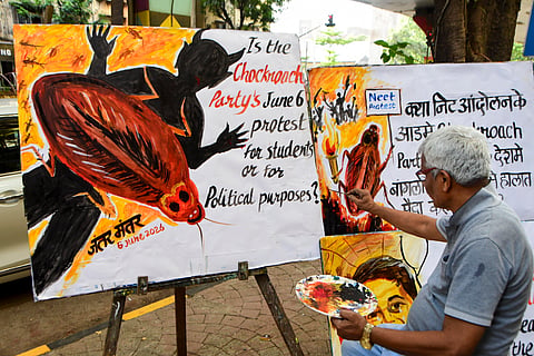 A man works on a poster on Cockroach Janta Party (CJP) ahead of CJP's protest on June 6th, in Mumbai, Maharashtra, Wednesday, June 3, 2026.