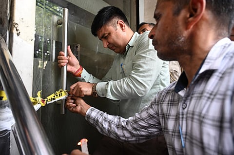 Delhi Police and local authorities seal buildings near Bed and Breakfast (B&B) hotel.