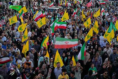 People with the flags of Iran and Lebanon's militant Hezbollah group attend a street festival celebrating the Muslim Shiite holiday of Eid al-Ghadir, the anniversary Prophet Muhammad naming his successor, Ali, who is revered as the first Shiite Imam, in Tehran, Iran, Thursday, June 4, 2026.