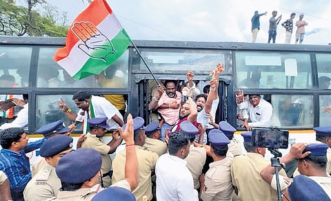 Supporters of former minister BZ Zameer Ahmed Khan being bundled into a bus after being detained by the police, in Bengaluru on Saturday