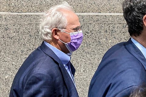 Former US Rep. Stephen Buyer, left, trails his lawyer as he leaves Manhattan federal court after pleading not guilty to charges that he participated in an insider trading scheme while working as a consultant, July 27, 2022, in New York.