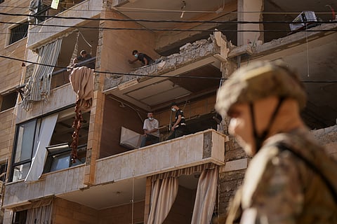 People check destroyed apartments that where hit by an Israeli airstrike in Dahiyeh, Beirut's southern suburb, Lebanon, Sunday, June 7, 2026.