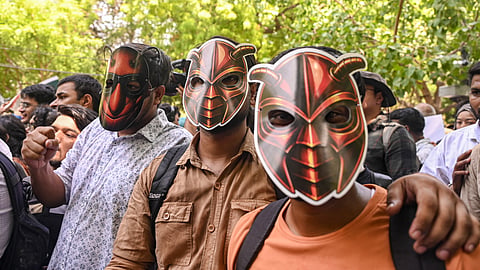 Supporters wear cockroach masks during protest.
